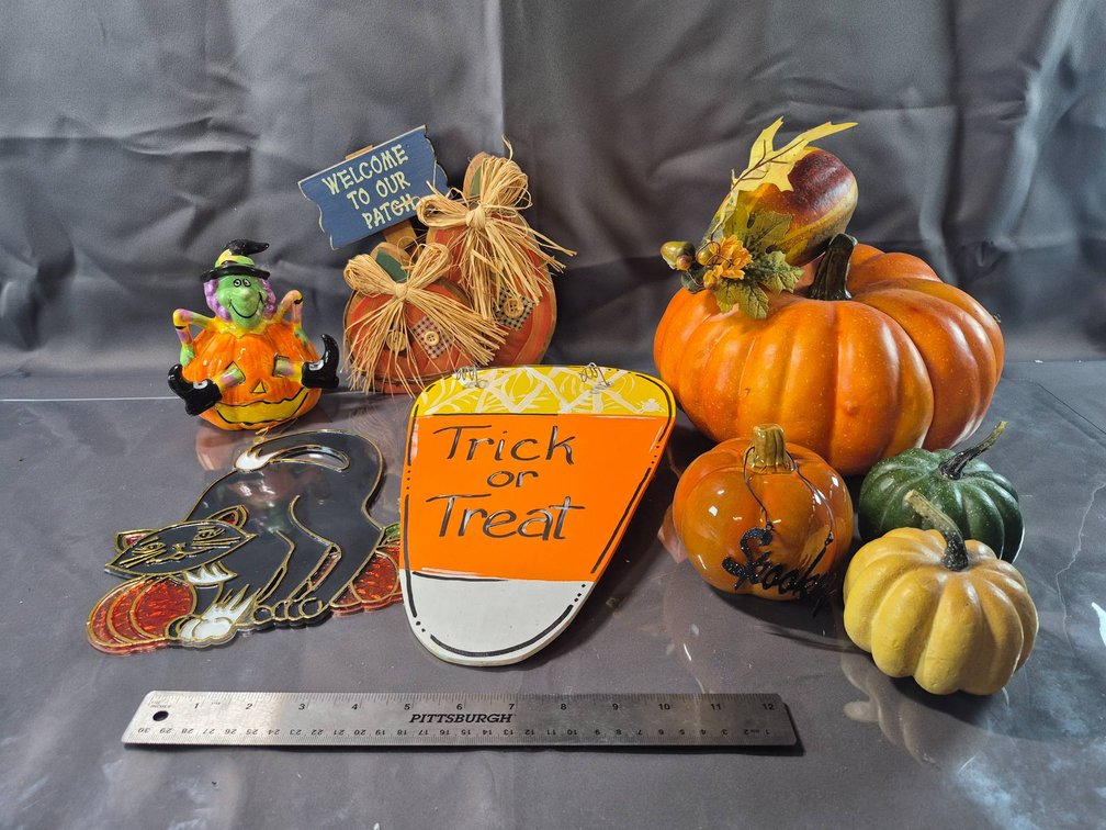 Halloween Decorations: Pumpkins, Witch Figurine, and Signs