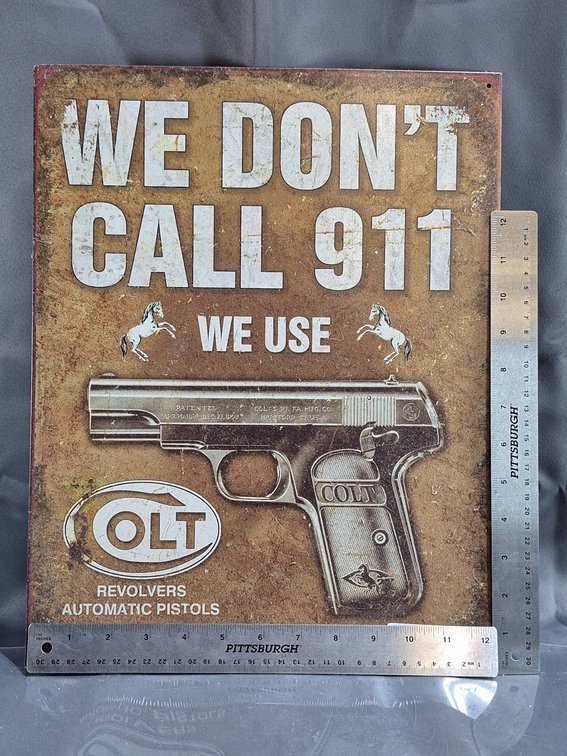 Metal Sign with Gun Motif and 'We Don't Call 911' Text