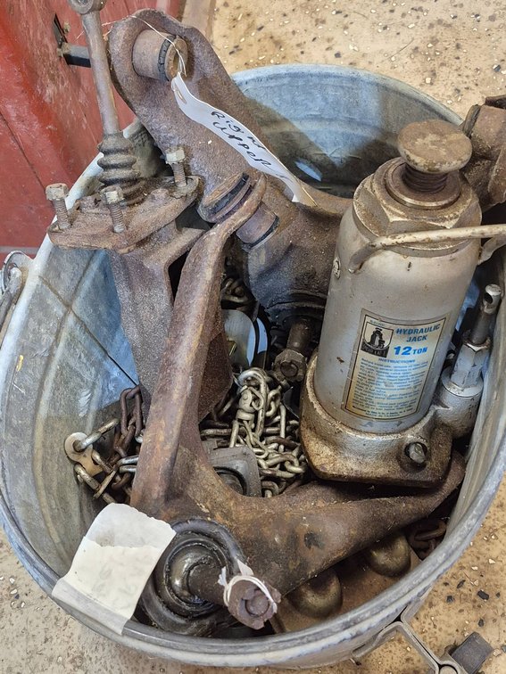 Metal Bucket With Tools, Hydraulic Bottle Jack, Chains, and Automotive Parts