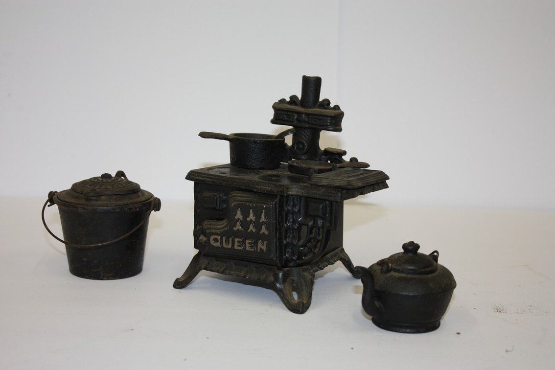 Vintage Cast-Iron Queen Stove With Pots, Pans, And Scraper