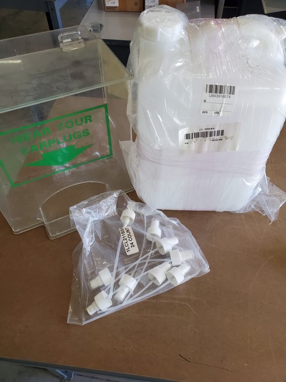 Lot 87: New plastic jug, nozzles and ear plug dispenser