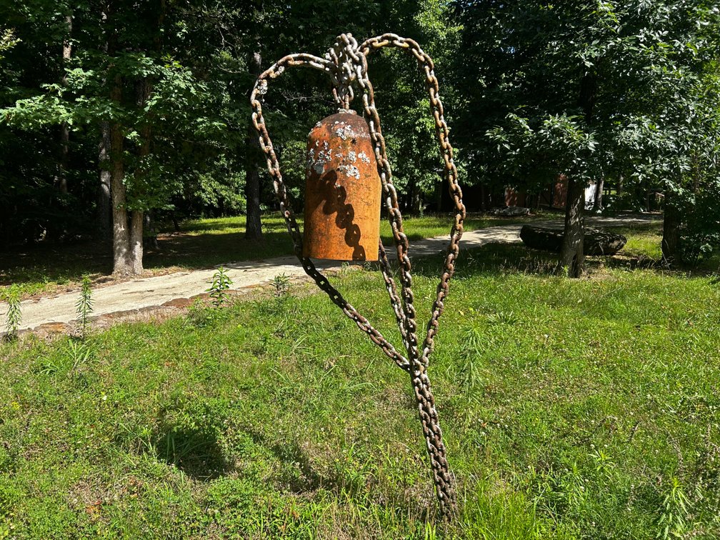 Large metal chain sculpture with bell