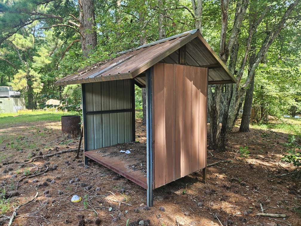 Woodshed w/ scrap metal.