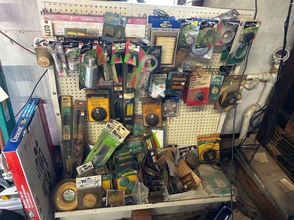 Rack full of lawn mower and weed eater parts