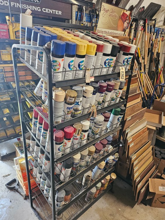 Large rack with spray paint cans estimated 130+ cans