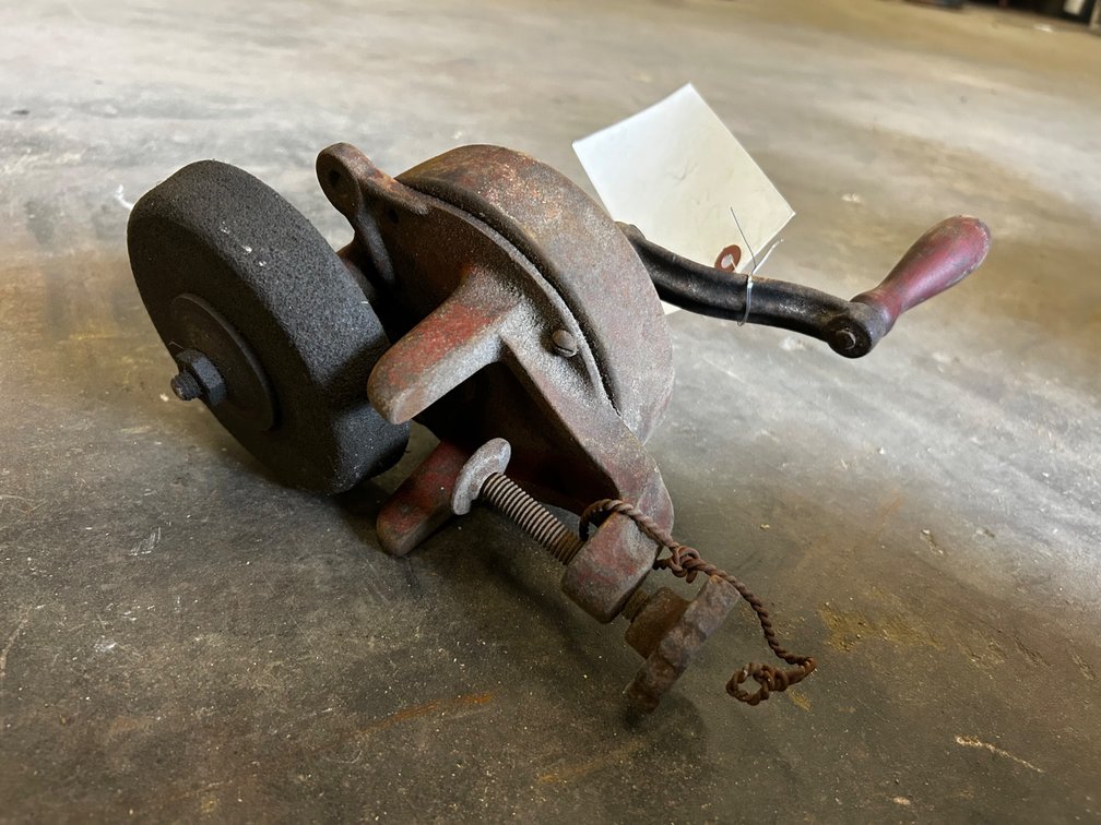 Clamp on hand powered grinding wheel