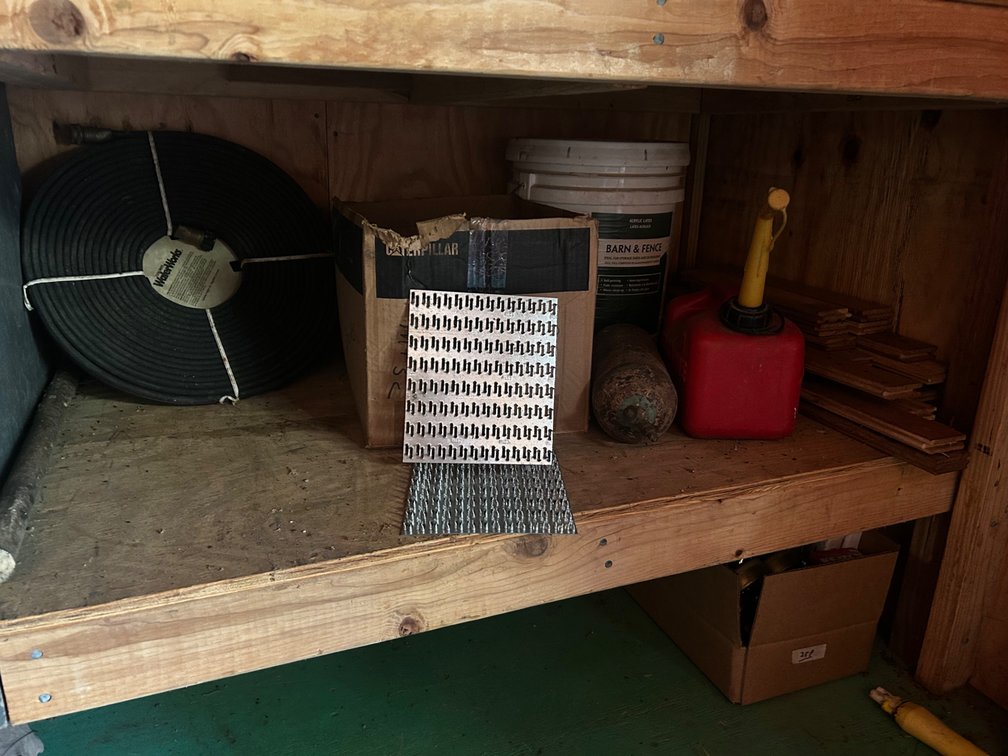 Box of truss plates, water hose, gas can, and more