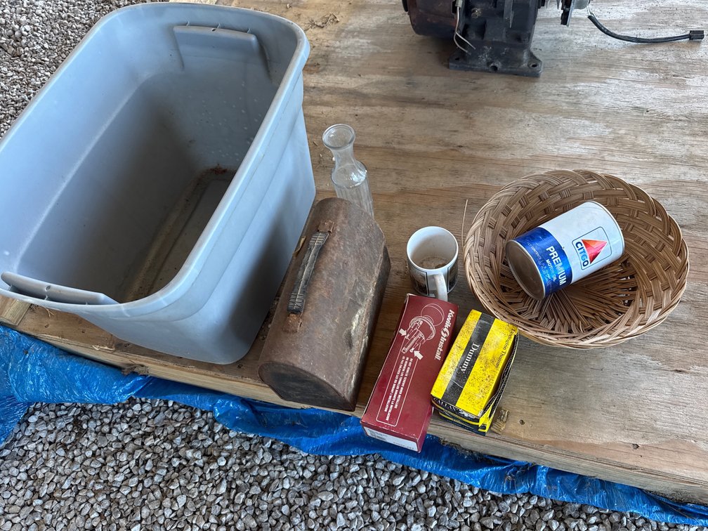 Gray tote with contents, lunch box,basket,door knobs,empty oil can