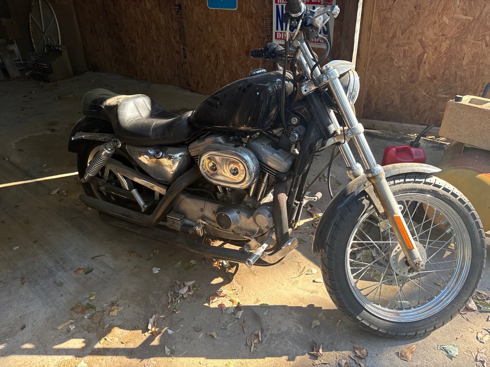 Harley Davidson sportster was running when parked