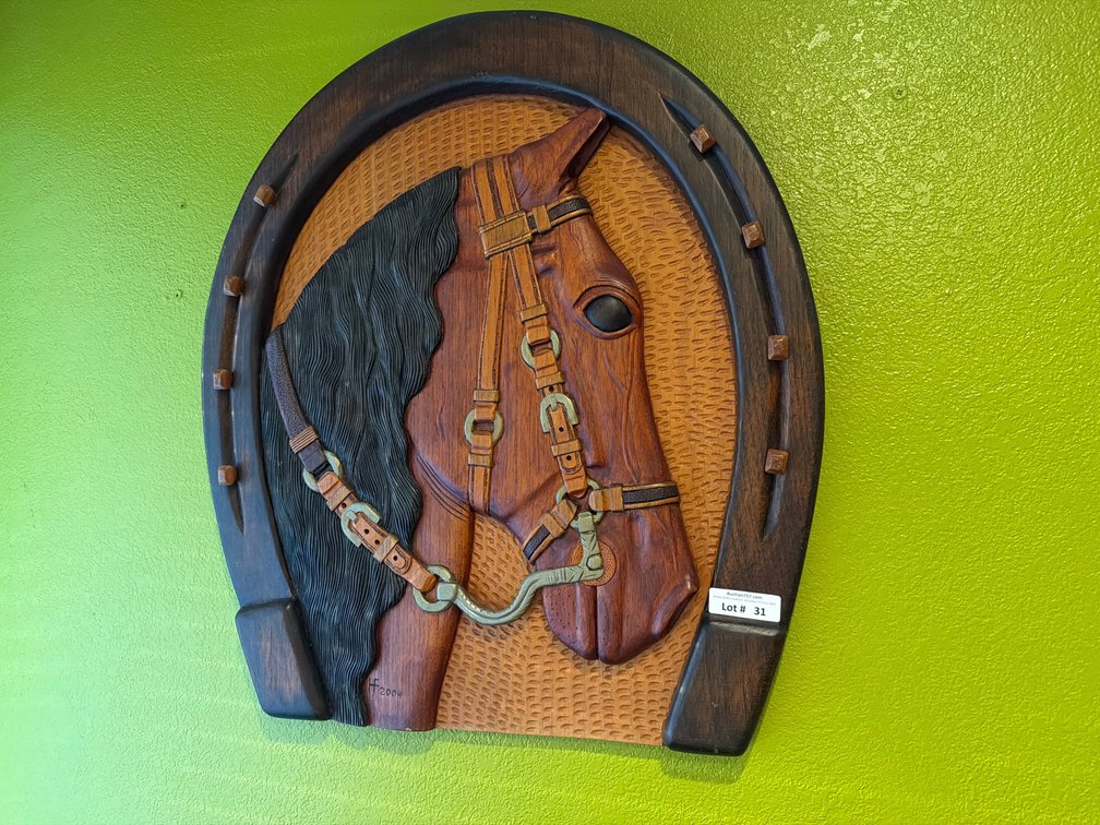 Hand carved wooden horse in horseshoe