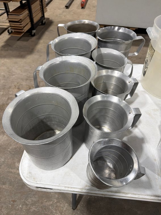 Lot: 9 aluminum measuring pitchers