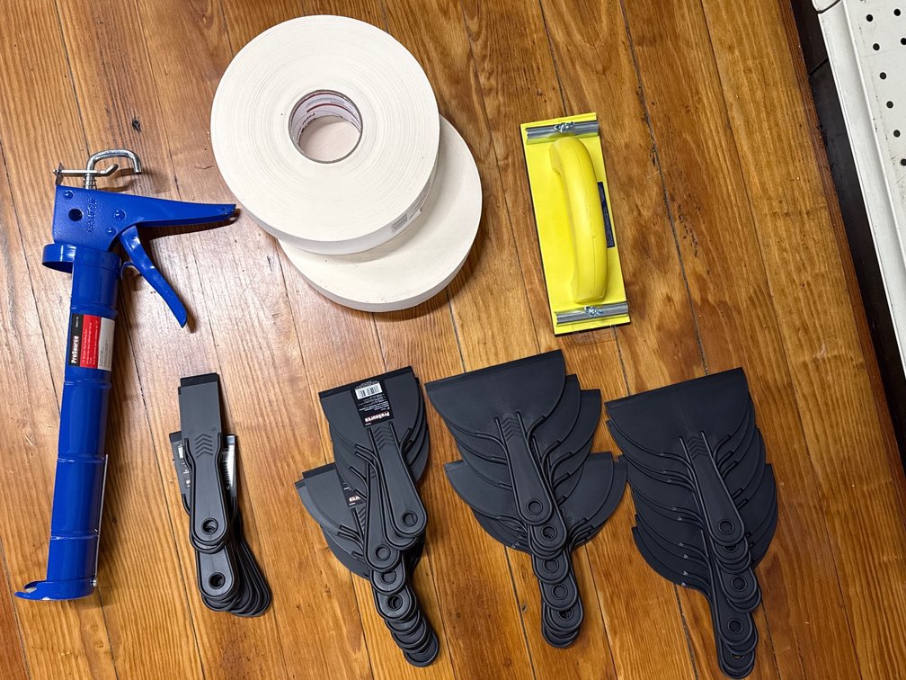 Scrapers, caulk gun, paper tape, hand sander