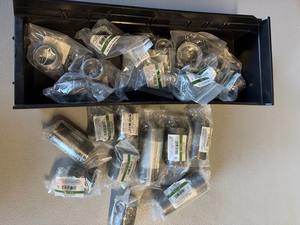 Lot of pipe nipples, plugs, and caps