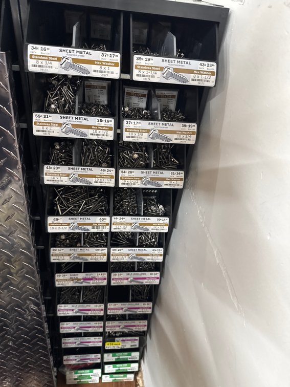 Large lot of sheet metal, hitch pins, self-drilling and bins