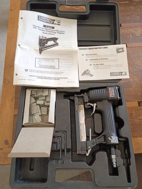 Campbell Hausfeld 1/4" Crown Finishing Stapler (Model SN258K) stored in its black molded carry case along with a manual