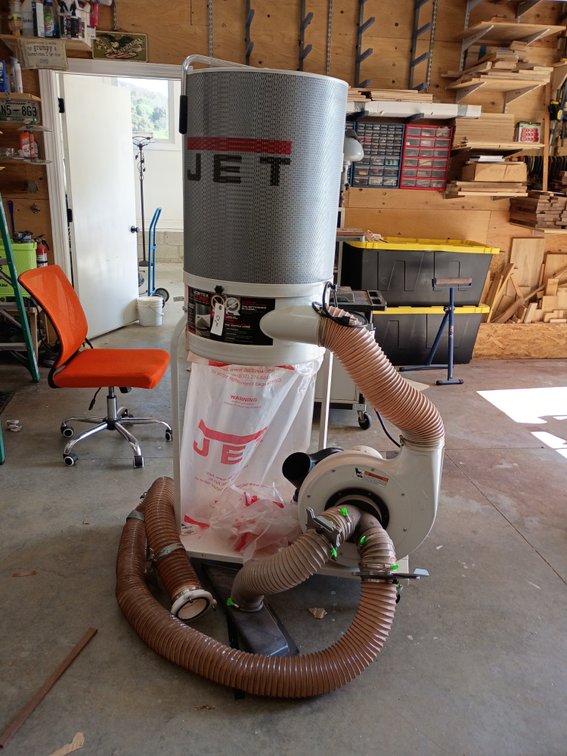 Jet Vortex Cone Dust Collector (likely a 1.5 HP DC-1100VX-CK or 2 HP DC-1200VX-CK1) equipped with an upper 2-micron canister filter, a lower collection bag, and flexible hoses.