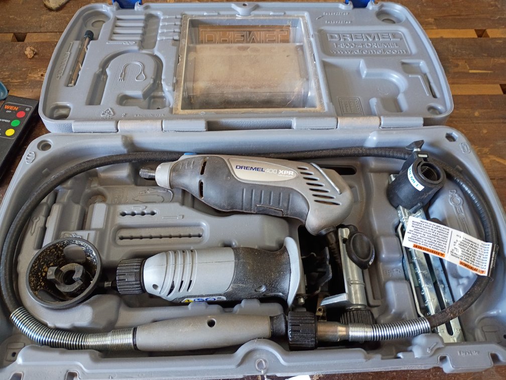 Dremel 400 XPR Variable Speed Rotary Tool Kit inside its gray hard-shell carrying case, complete with a rotary tool, flex shaft attachment, and various accessories