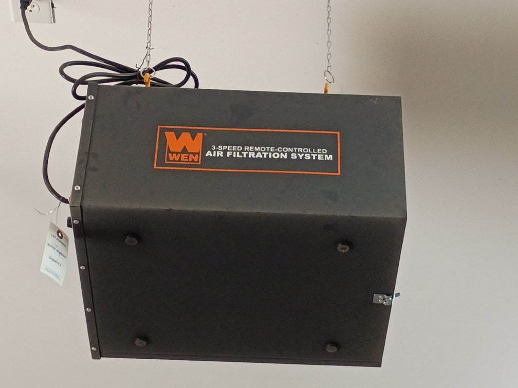 WEN 3-Speed Remote-Controlled Air Filtration System (such as model 3410 or a similar variant) hanging from a wall or ceiling bracket