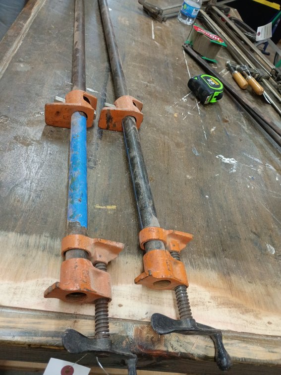 2 vintage Pony 3/4-inch pipe clamps (such as model 50 or 5203) mounted on long threaded steel pipes 40in.