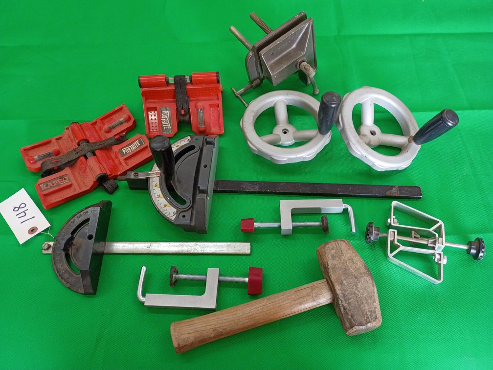 Variety of clamps hammer handles and measuring tools