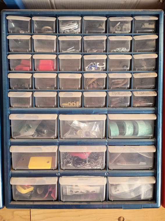 plastic multi-drawer small parts and hardware storage cabinet, similar to a 42-compartment organizer with items