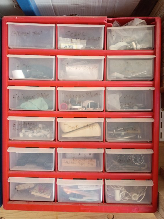 plastic multi-drawer small parts and hardware storage cabinet, similar to a 42-compartment organizer with items