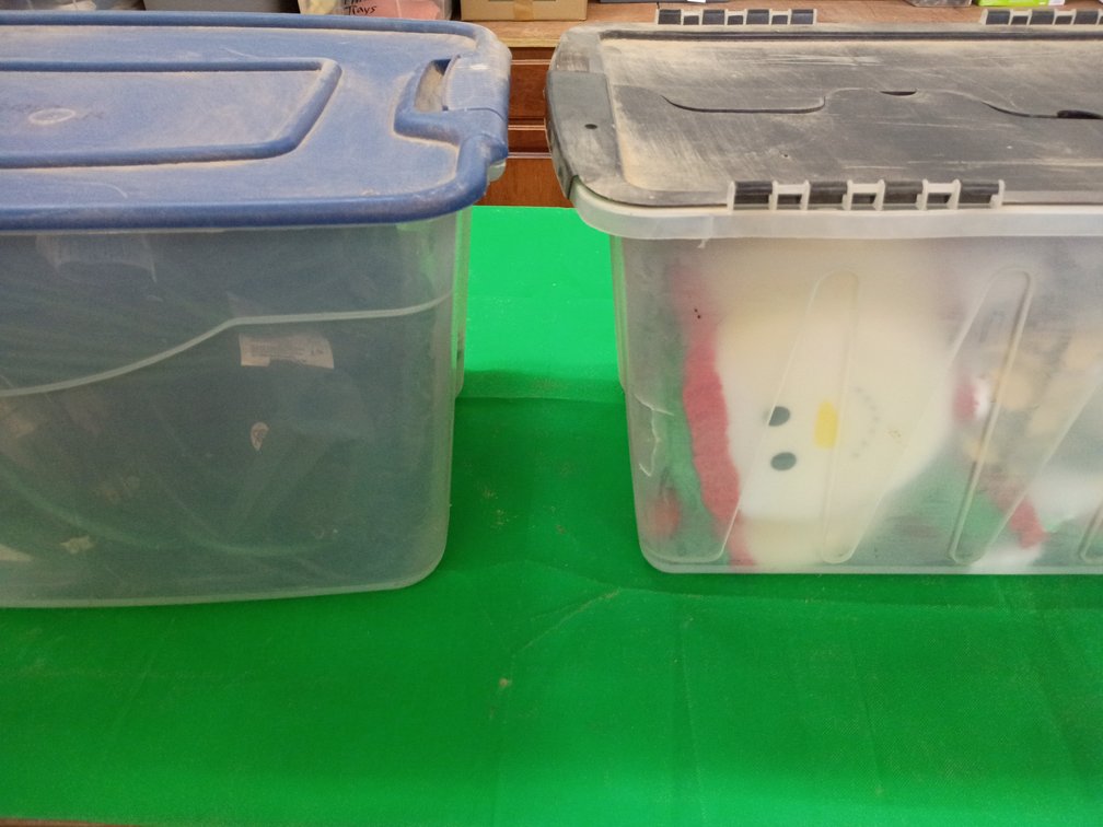 Two tubs extension cords and Christmas items