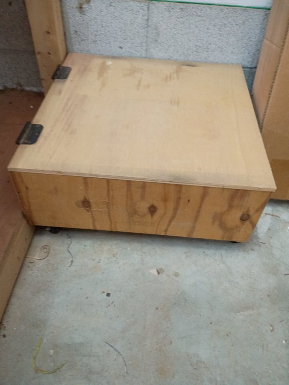 Wooden box on rollers with hinges for lid