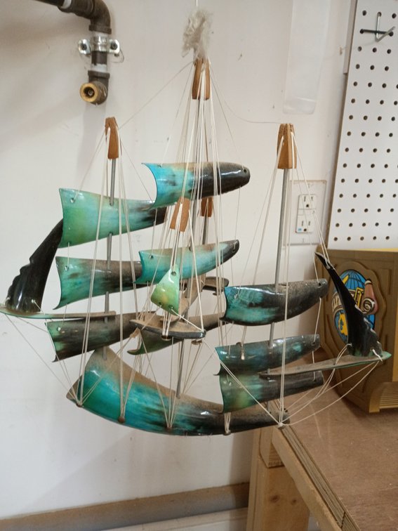 vintage, hand-crafted decorative sailboat model made from genuine animal horn (such as cow or buffalo horn)