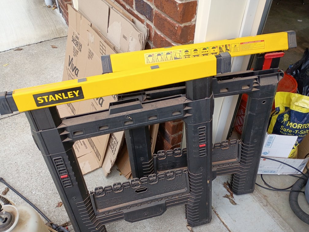 Two black and yellow Stanley sawhorses