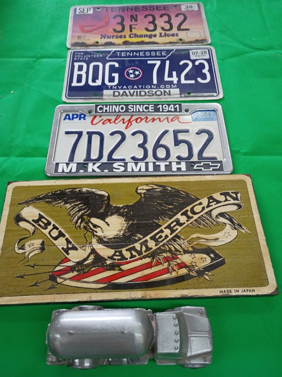 Three tags by American wooden sign and a suburban propane piggy bank with change in it