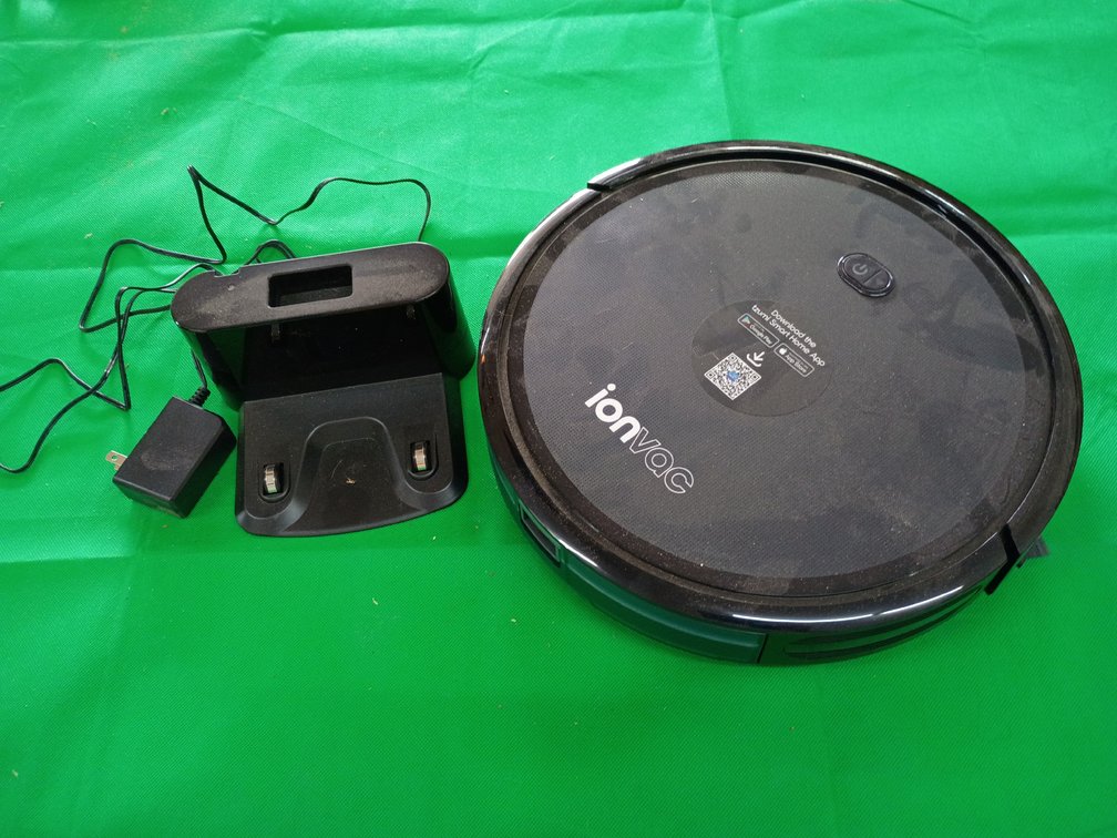 black Ionvac SmartClean 2000 Robovac (Model #7687), a multi-surface robotic vacuum cleaner featuring Wi-Fi connectivity, app control, a handheld remote, and a charging dock