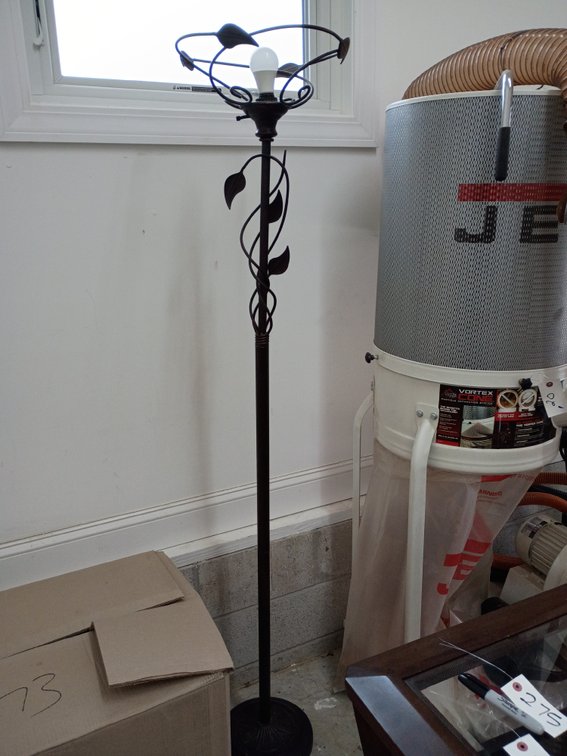 dark bronze-finished metal torchiere floor lamp featuring a decorative vine and leaf design