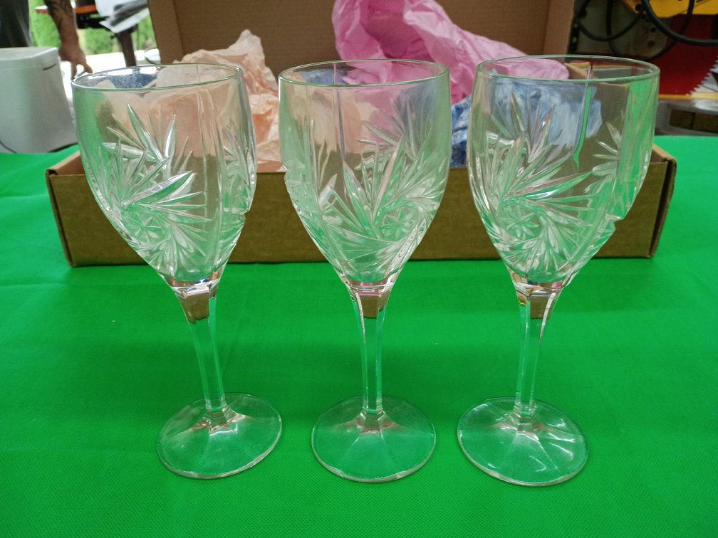 Set of eight vintage cut crystal wine or water goblets featuring a starburst and leaf pattern on tall stems