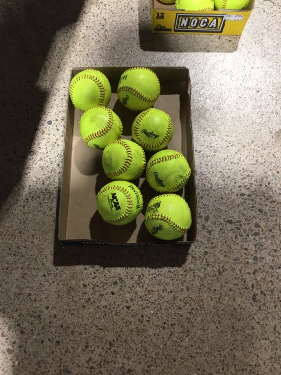 Eight fast pitch softballs