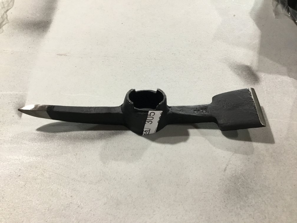 A forged steel pick and tamper head
