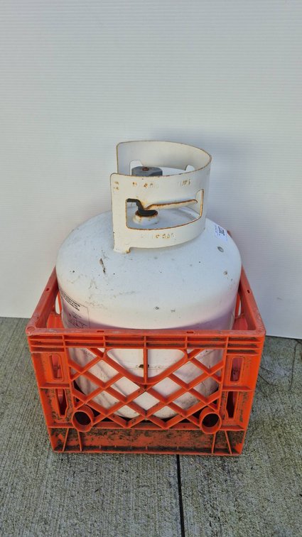 Empty Propane Tank in Plastic Crate