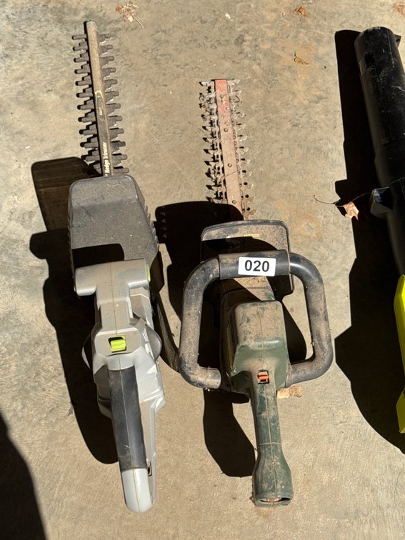 Two electric hedge trimmers