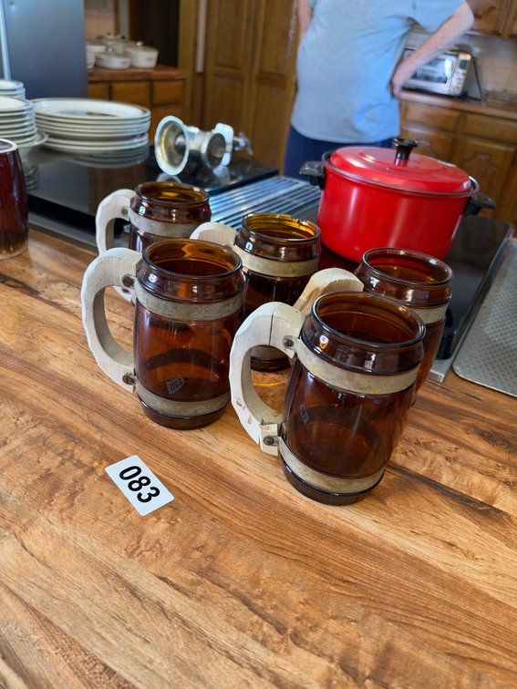 5 brown mugs with wooden handles