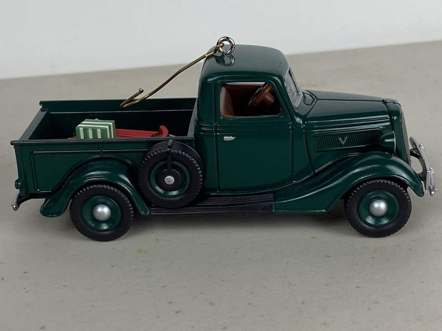 A green pickup truck Christmas Ornament  with Sled and gifts in the back- no box