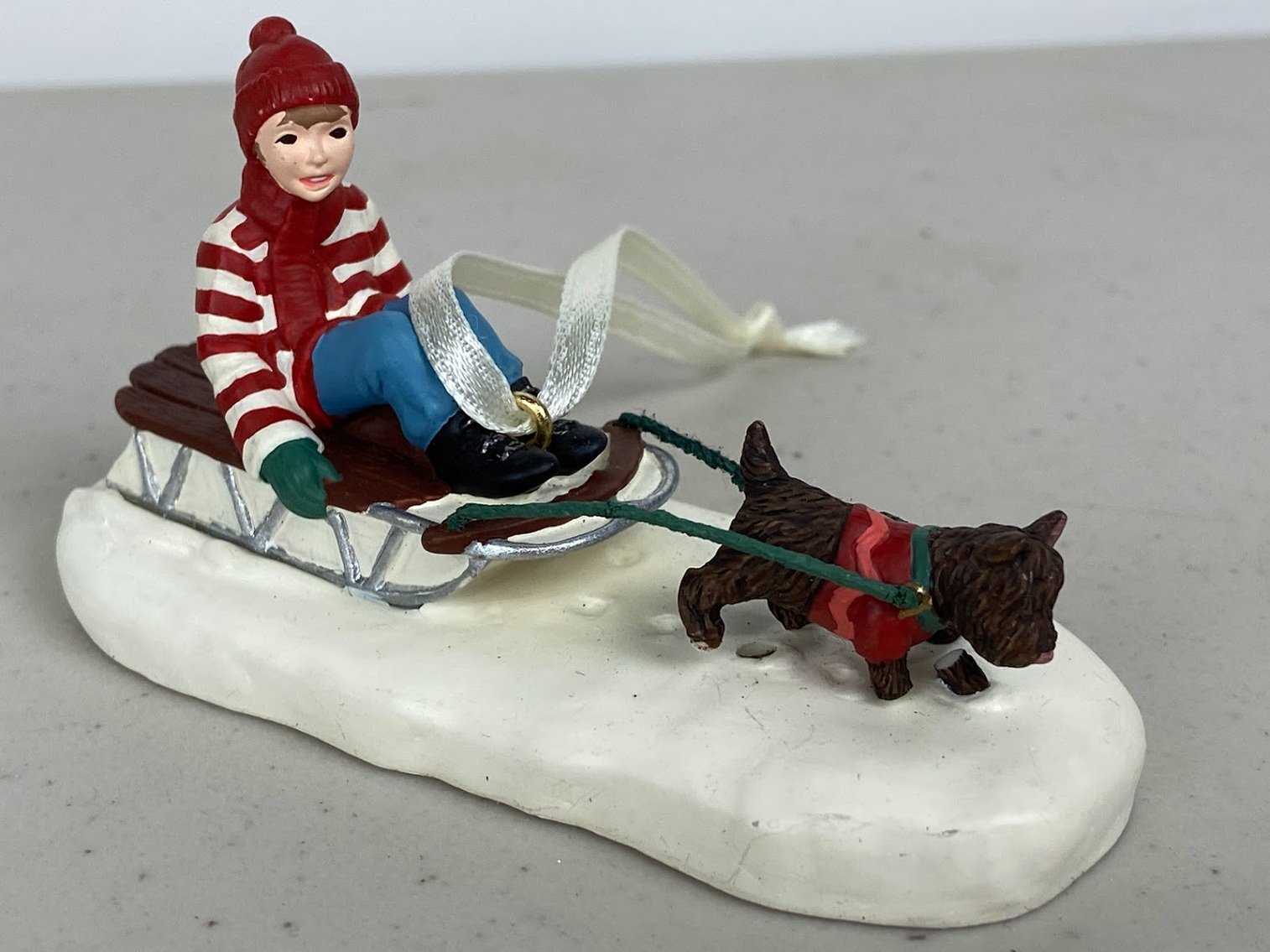 Hallmark -2001 Thomas Kinkade- Boy riding a sleigh with a black dog pulling- no box