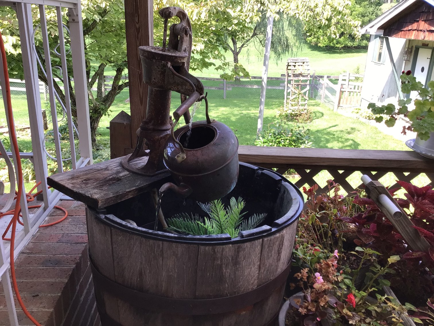 Image for Fountain made from half wine barrel and hand pump
