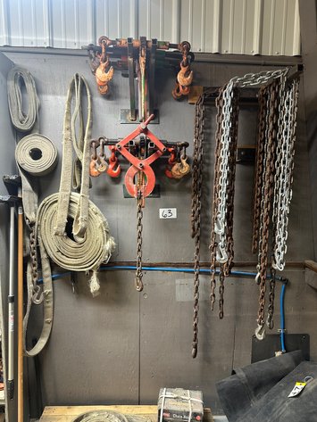 Image for Assorted Rigging Slings, Chains, Wood Grabbing Clamp, and Chain Binders on Wall