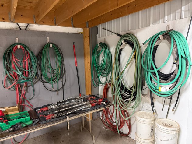 Image for Assorted Water / Air Hoses Hanging in Machine Shop