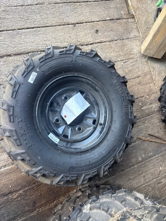 Polaris 26X 11. 00R 12 tire and rim.