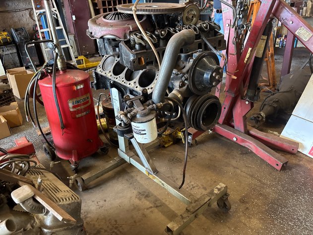 Image for 350 V8 engine block and parts on engine stand