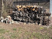 Stack Of Firewood With Statues