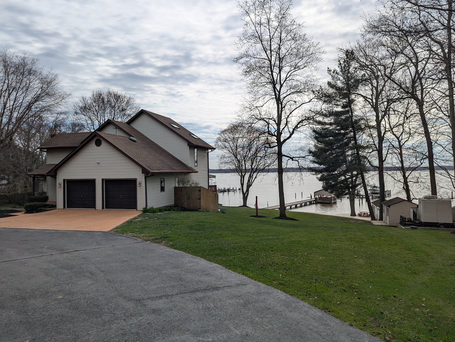 Image for LARGE WATERFRONT PROPERTY/ 2-STORY CONTEMP. HOME W/ ATT. 2-CAR GARAGE & 1-BR COTTAGE HOME/(4) PARCELS TOTALING 3.35 +/- AC SOLD IN THE ENTIRETY/ 155' FT FRONTAGE ON BUSH RIVER W SANDY BEACH/ LARGE DOCK W/ (10) +/- BOAT SLIPS, TIKI BAR & MORE!
