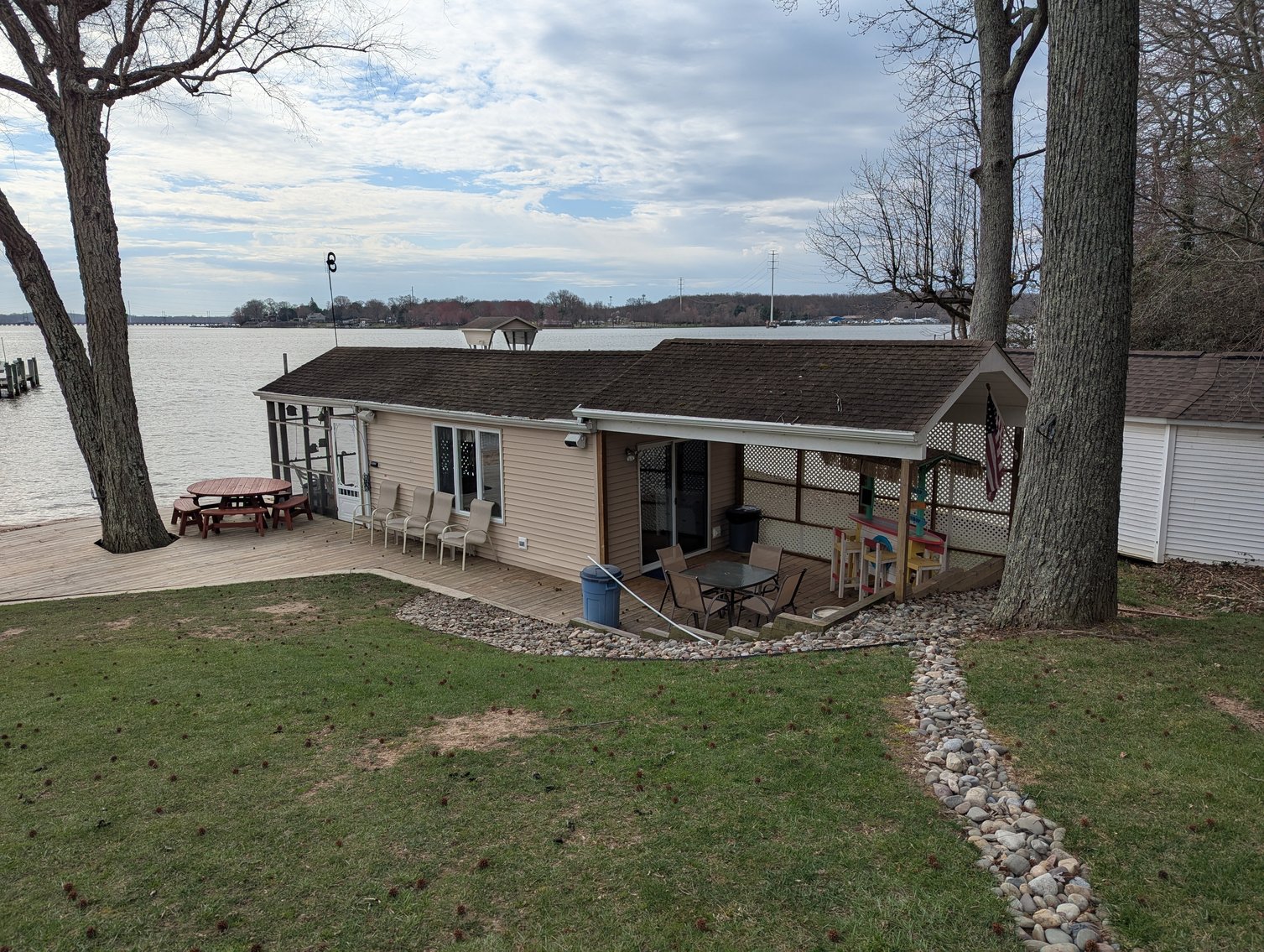 Image for LARGE WATERFRONT PROPERTY/ 2-STORY CONTEMP. HOME W/ ATT. 2-CAR GARAGE & 1-BR COTTAGE HOME/(4) PARCELS TOTALING 3.35 +/- AC SOLD IN THE ENTIRETY/ 155' FT FRONTAGE ON BUSH RIVER W SANDY BEACH/ LARGE DOCK W/ (10) +/- BOAT SLIPS, TIKI BAR & MORE!