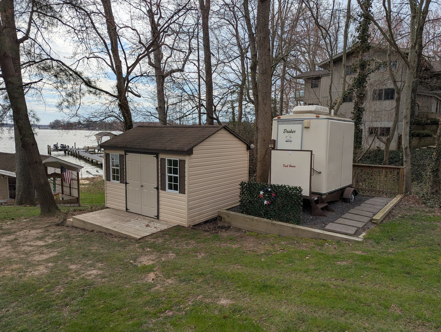 Image for LARGE WATERFRONT PROPERTY/ 2-STORY CONTEMP. HOME W/ ATT. 2-CAR GARAGE & 1-BR COTTAGE HOME/(4) PARCELS TOTALING 3.35 +/- AC SOLD IN THE ENTIRETY/ 155' FT FRONTAGE ON BUSH RIVER W SANDY BEACH/ LARGE DOCK W/ (10) +/- BOAT SLIPS, TIKI BAR & MORE!